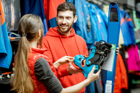 couple shopping at a ski shop for ski boots